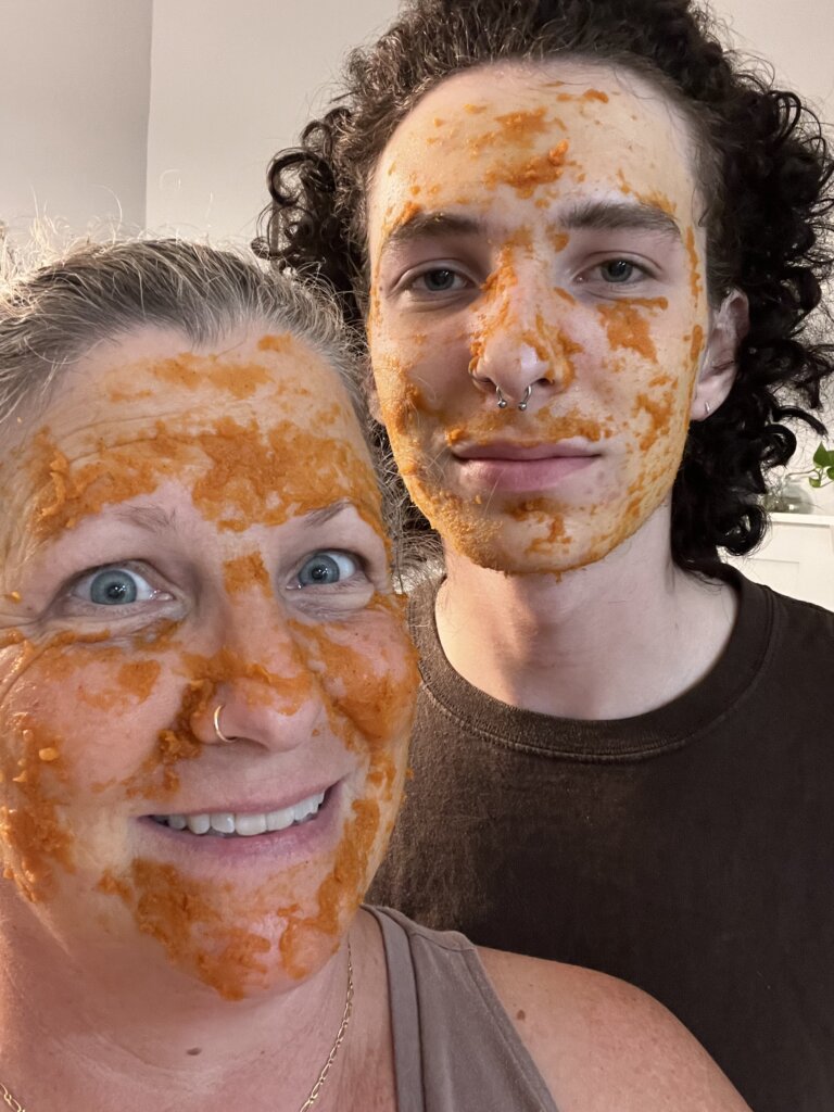 mother and teen son with pumpkin beauty face masks