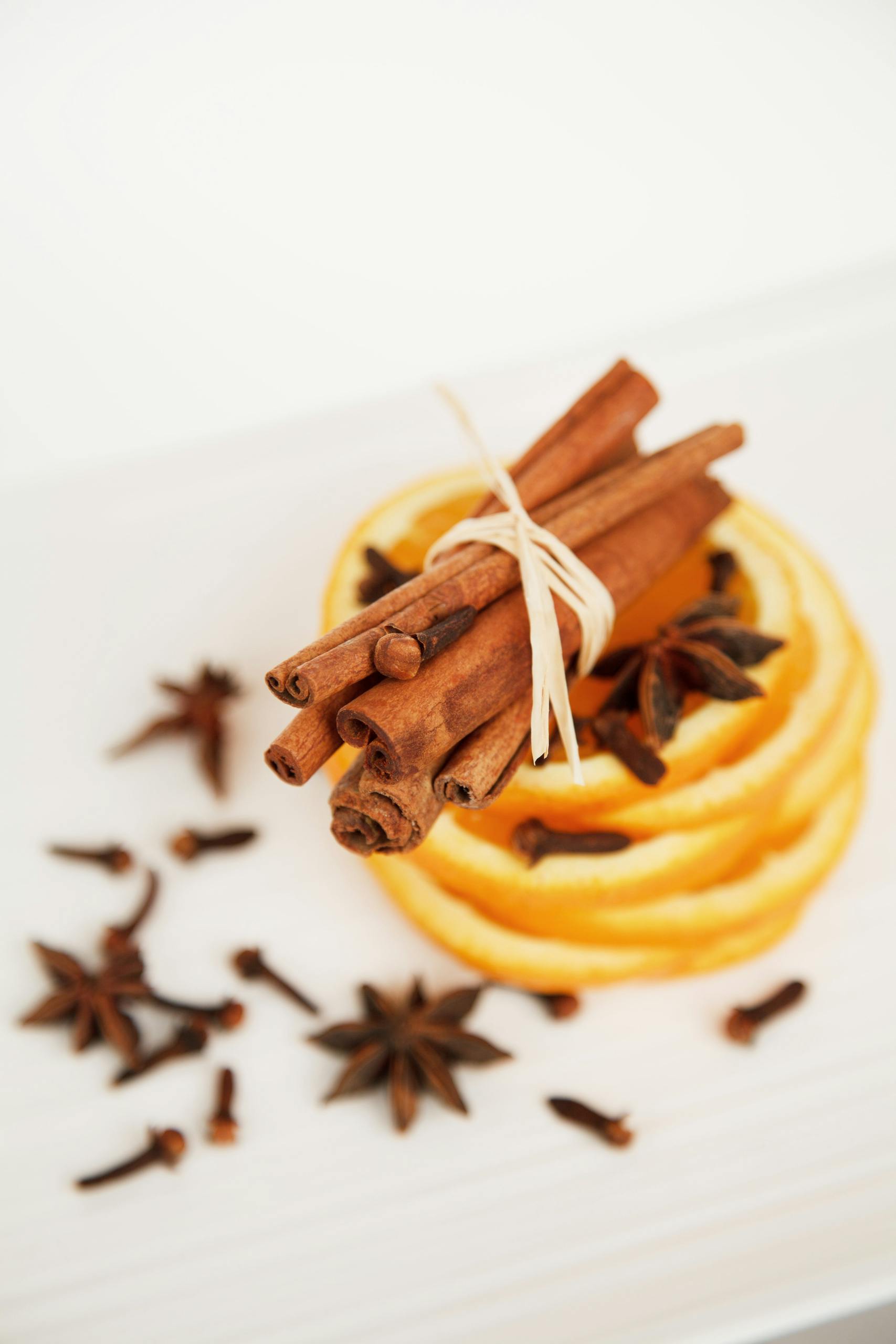 slices of orange with a bundle cinnamon sticks and anise