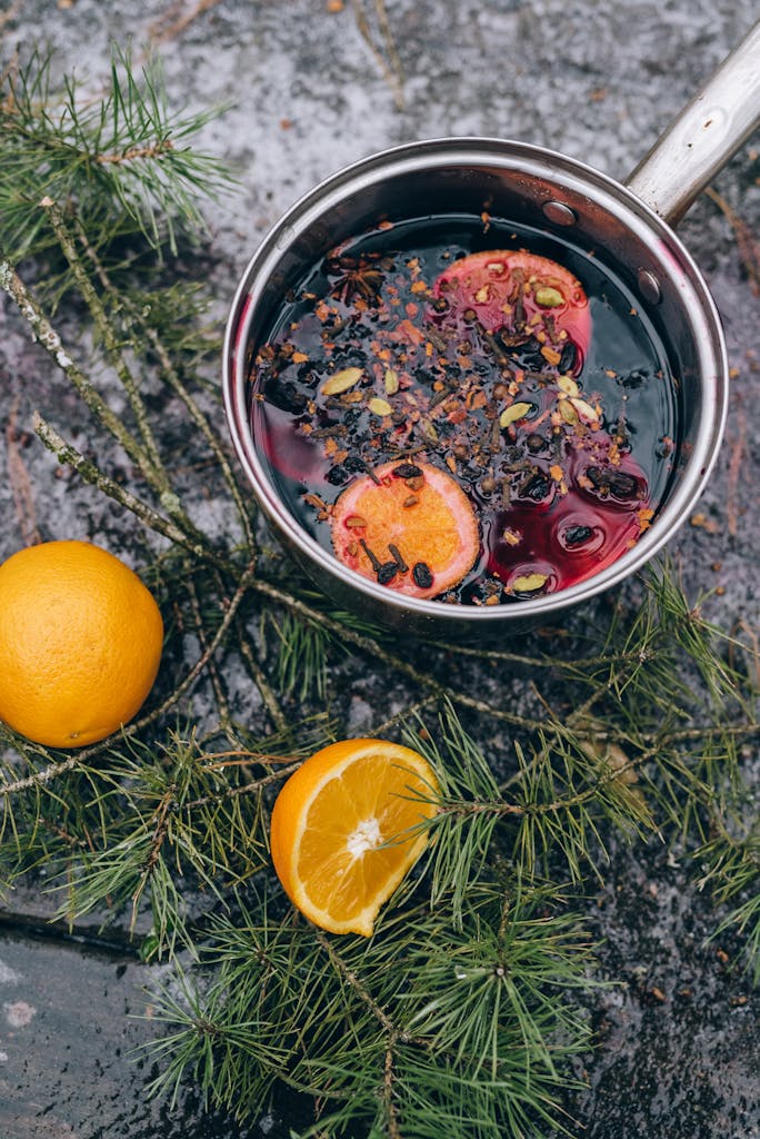 Orange Fruit and spices  in Stainless Steel Pot