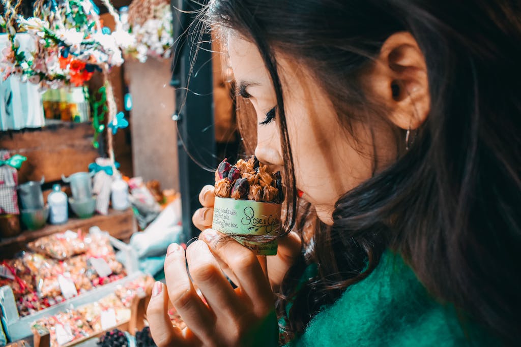 Woman Holding spices to her nose and smelling them with her eyes closed