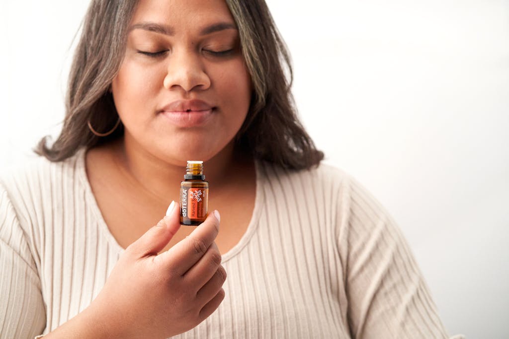 Woman Holding Small Brown Bottle