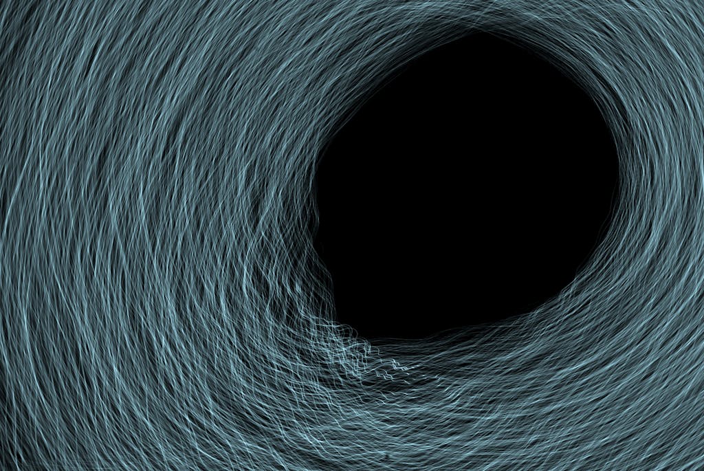 A dark hole with light waves spinning in a circle